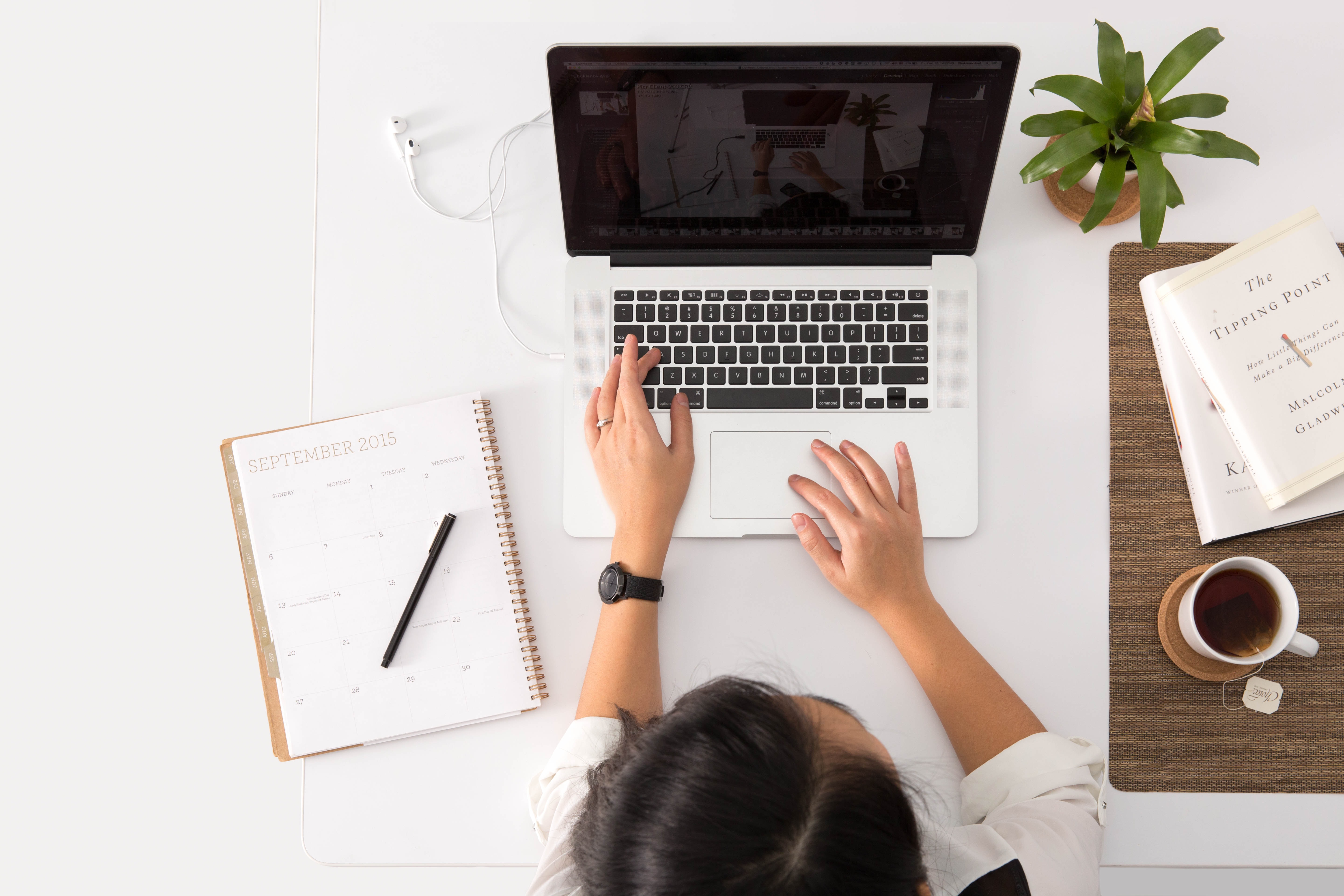 woman typing on her laptop